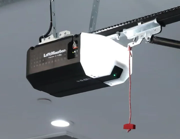 LiftMaster garage door opener mounted to the ceiling with chain rail and emergency release cord